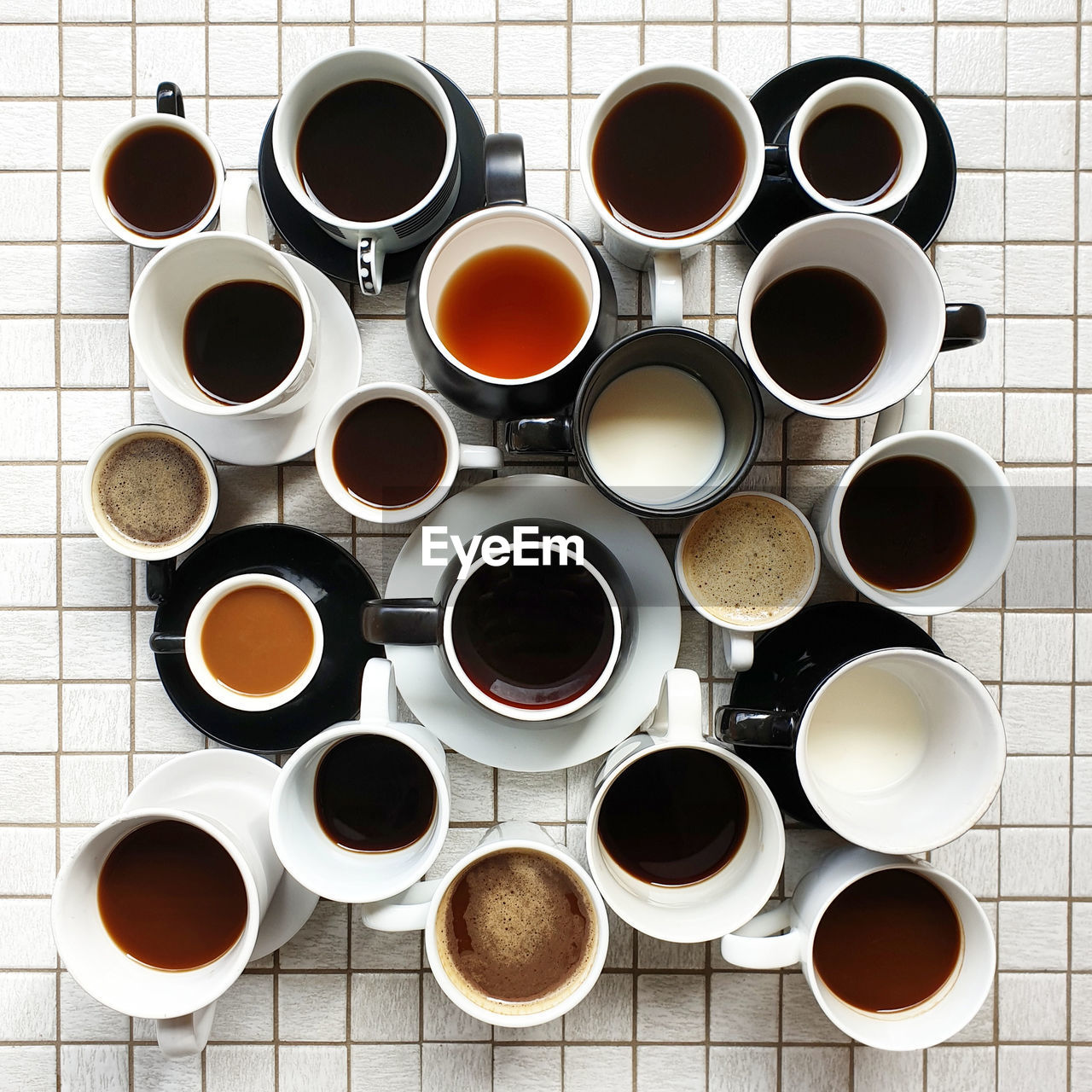 High angle view of multiple collection coffee cups on tiled table