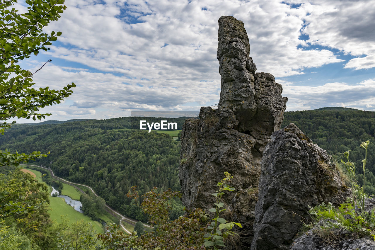 Rock formation and valley view of franconian switzerland against cloudy sky