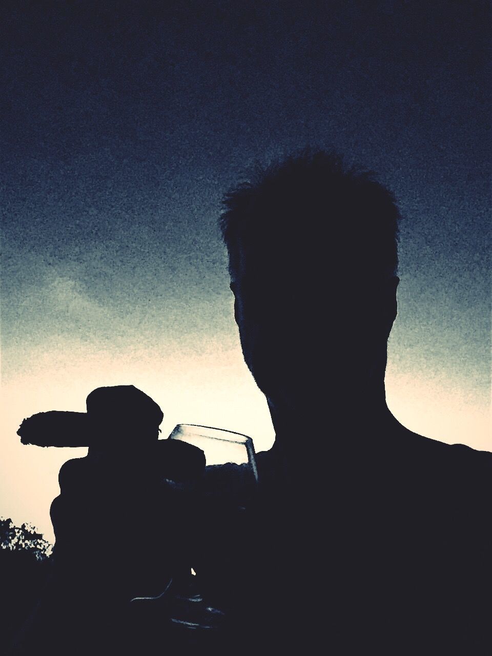 LOW ANGLE VIEW OF SILHOUETTE WOMAN STANDING AGAINST SKY