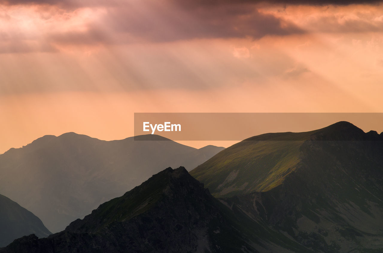 Scenic view of mountains against sky during sunset