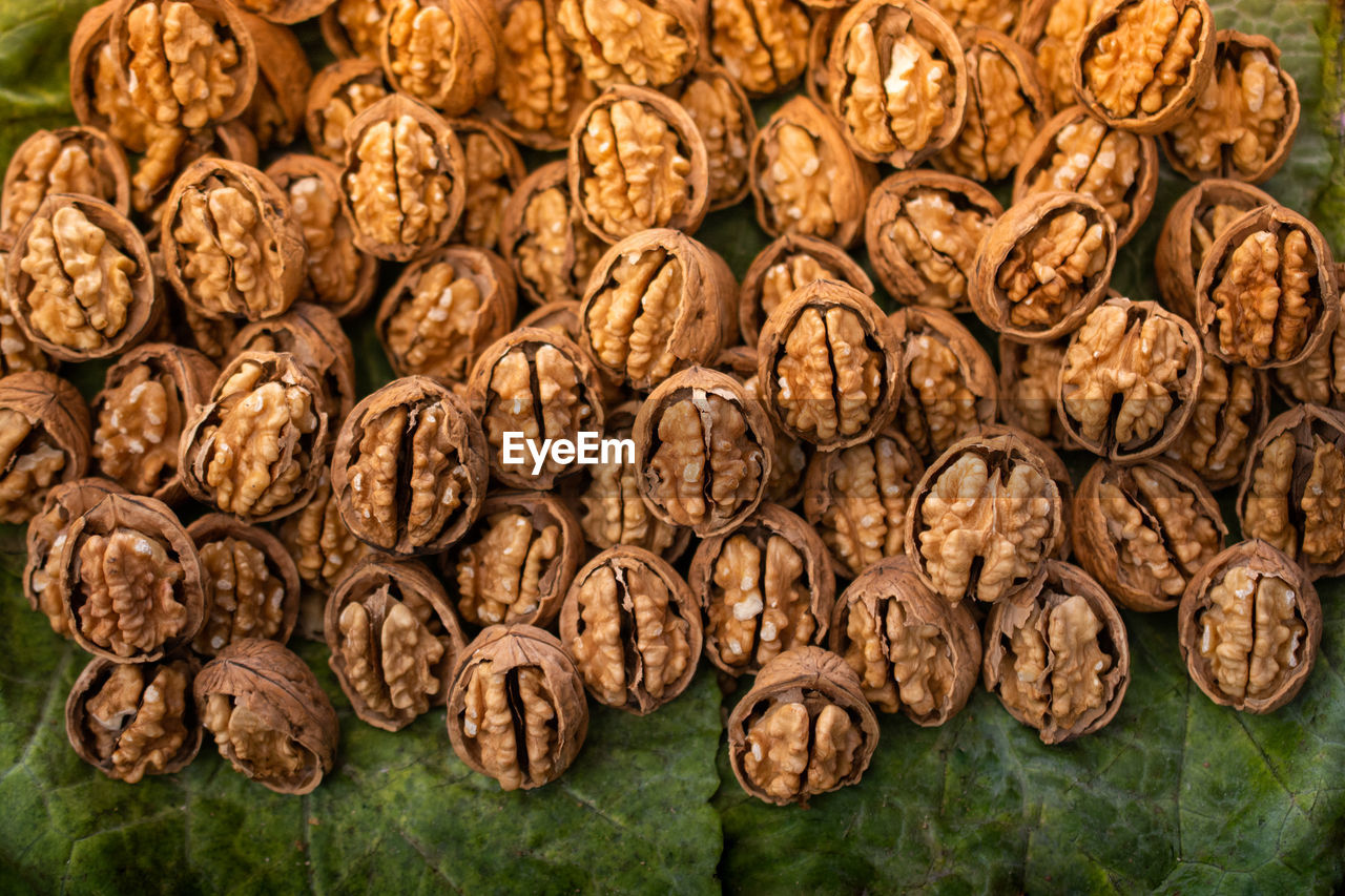 Walnuts in shell heap pattern as organic food background