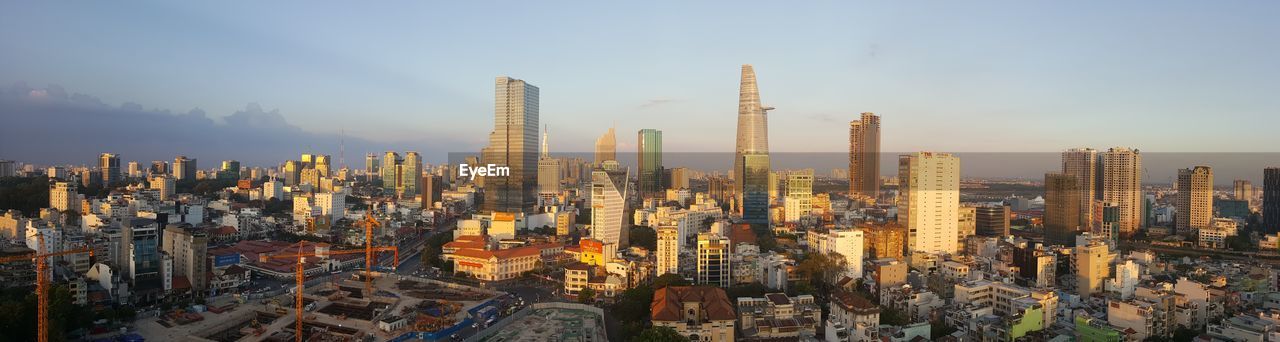 Panoramic shot of modern buildings in city against sky