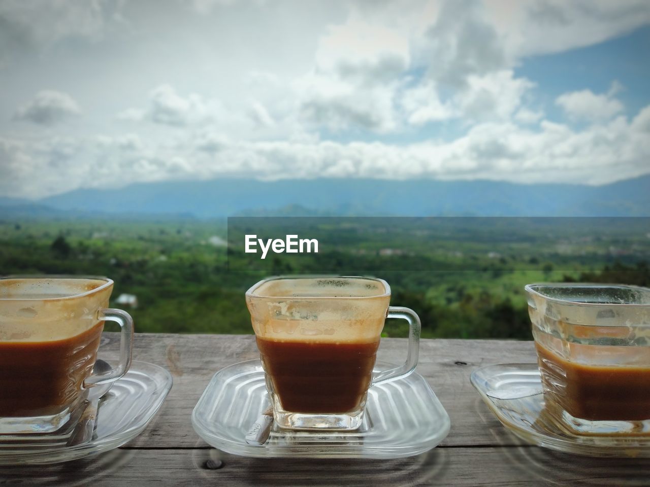 Coffee cup on table against sky