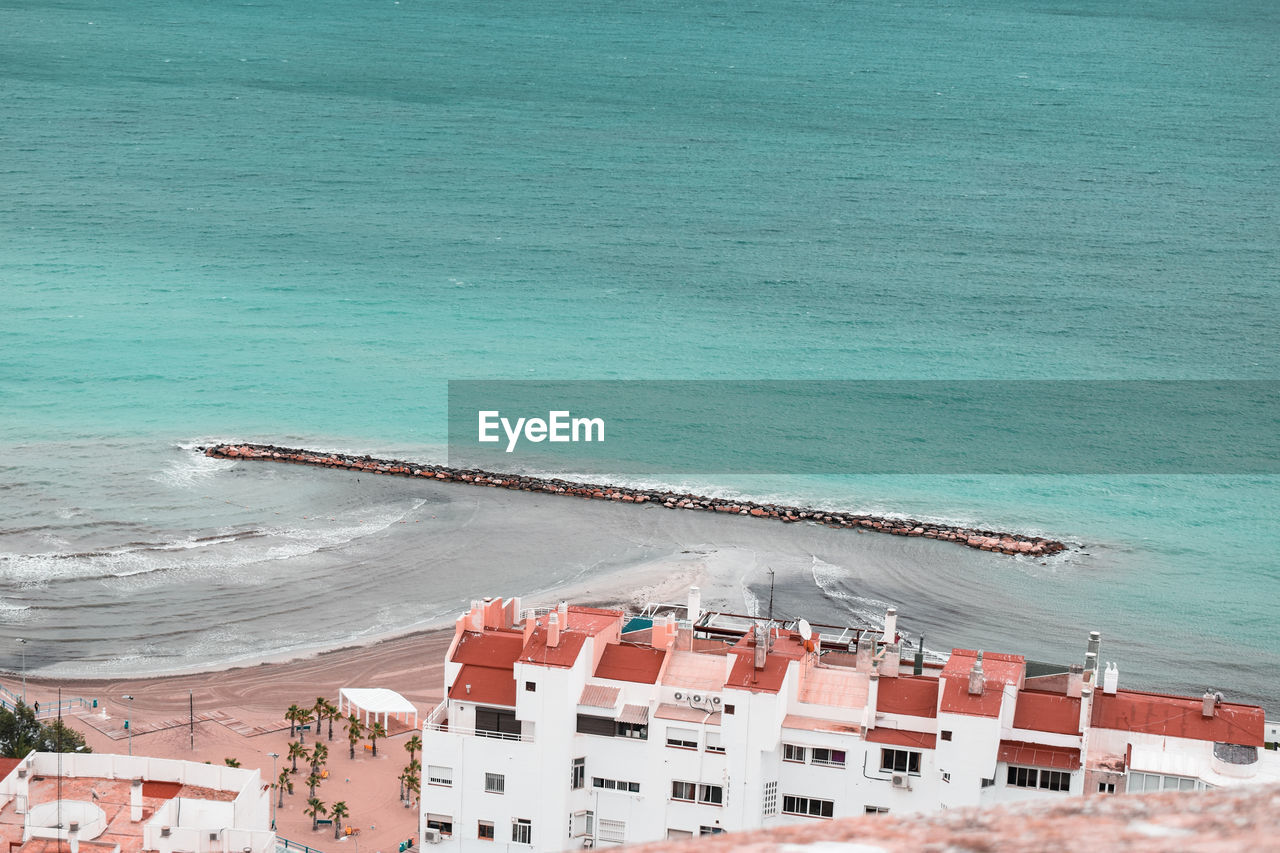 High angle view of buildings by sea 