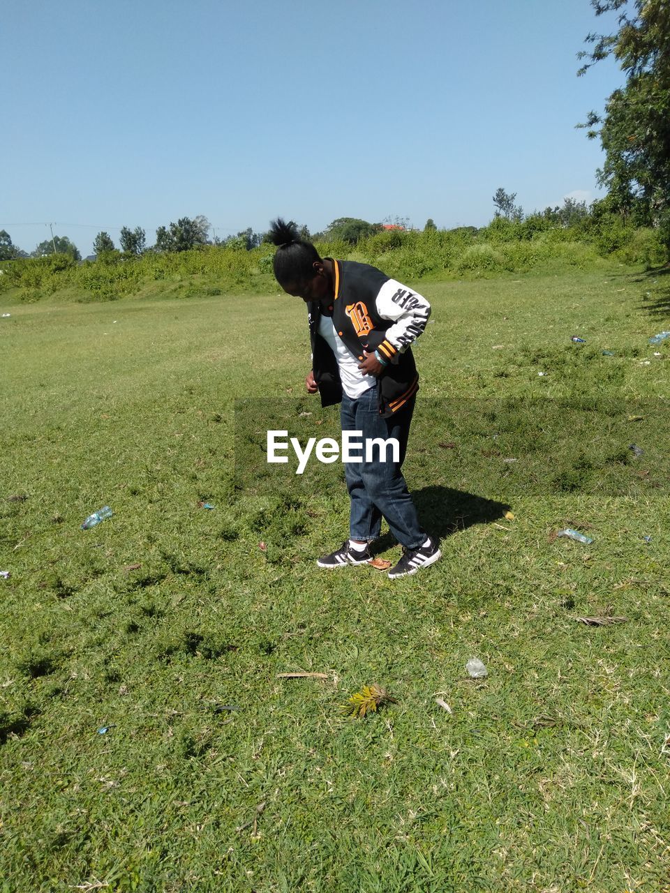 full length, plant, grass, nature, leisure activity, sky, adult, men, one person, land, green, day, meadow, activity, landscape, field, environment, clear sky, casual clothing, lifestyles, outdoors, sunlight, sports, sunny, standing, copy space, child