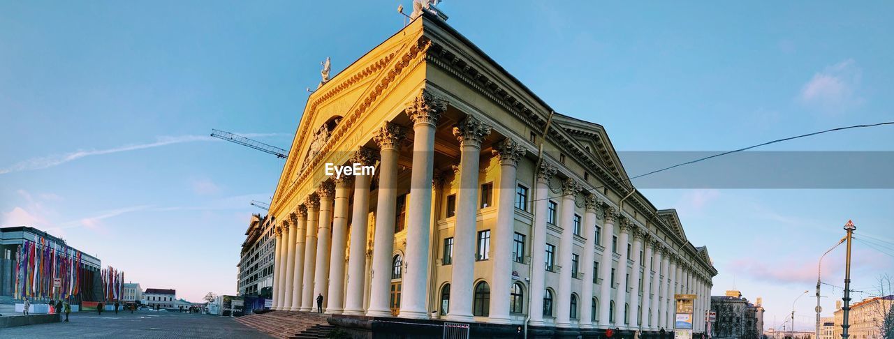 LOW ANGLE VIEW OF BUILDINGS AGAINST BLUE SKY