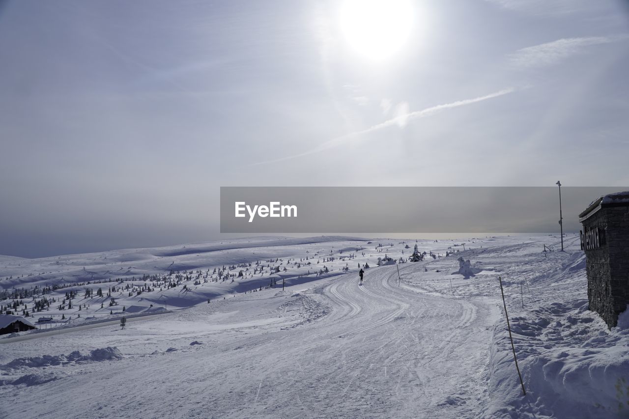 SNOW COVERED LANDSCAPE AGAINST SKY