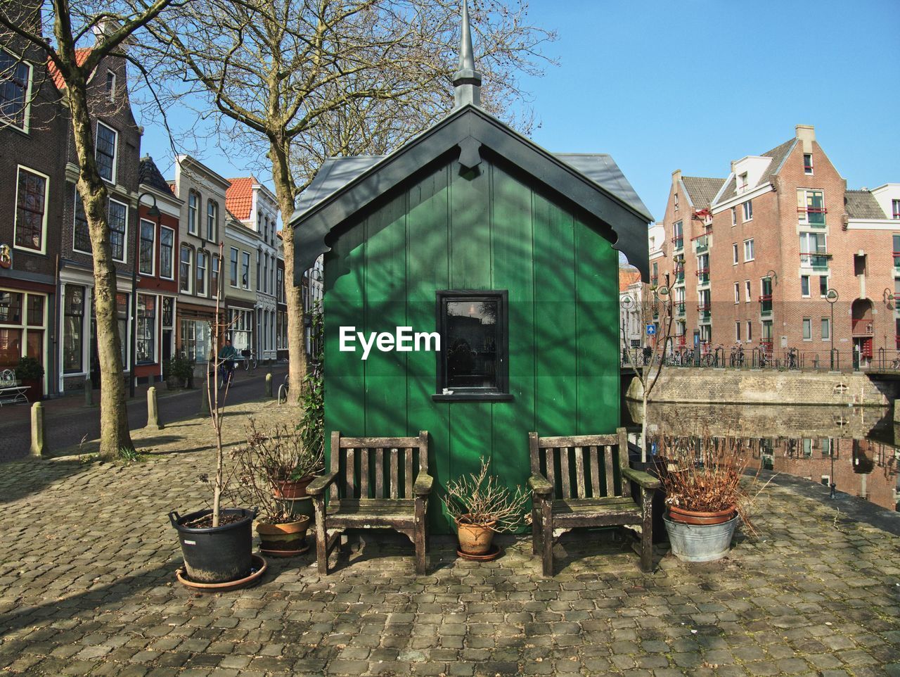 Chairs and tables against buildings in city