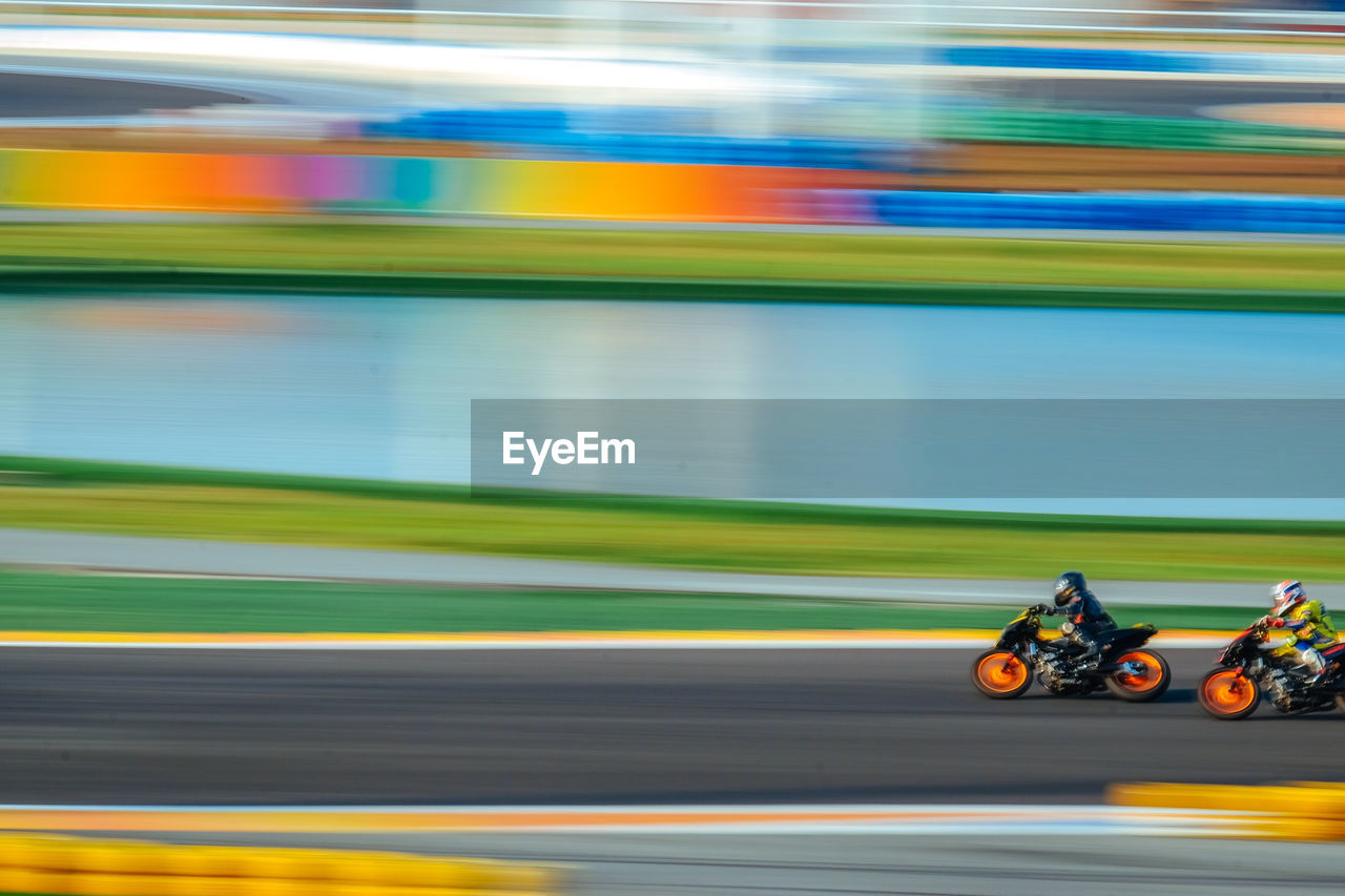 Blurred motion of sportsmen racing on motorcycles at race