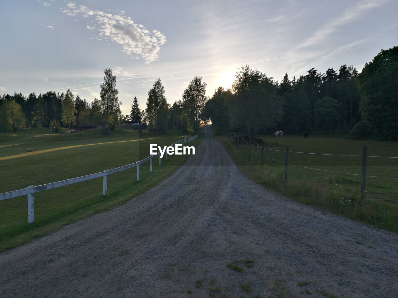 EMPTY ROAD AMIDST FIELD AGAINST SKY