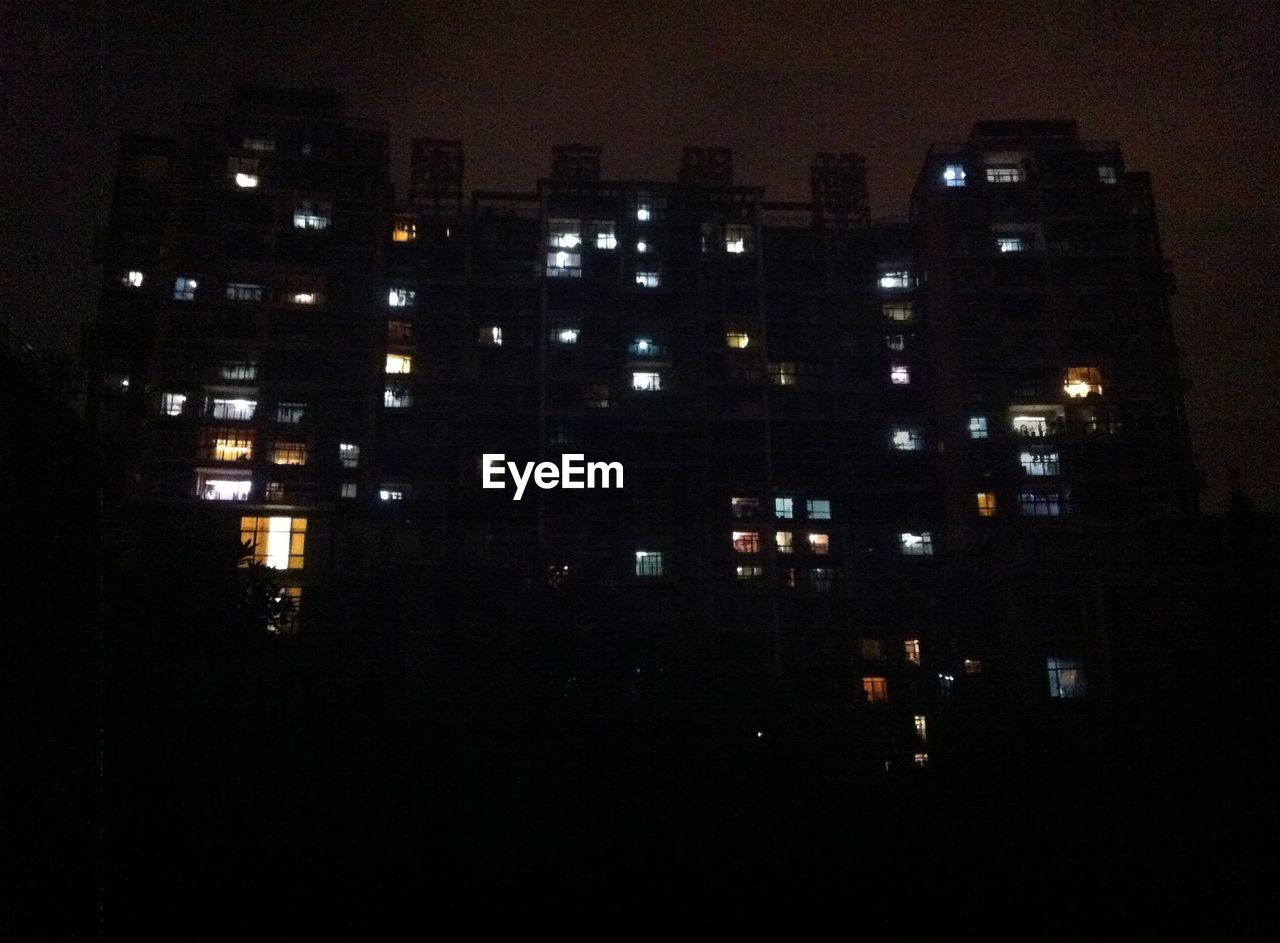 ILLUMINATED BUILDINGS IN CITY AT NIGHT