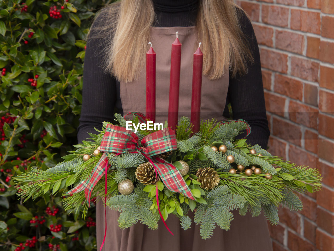 Holiday centerpiece with candles and greenery