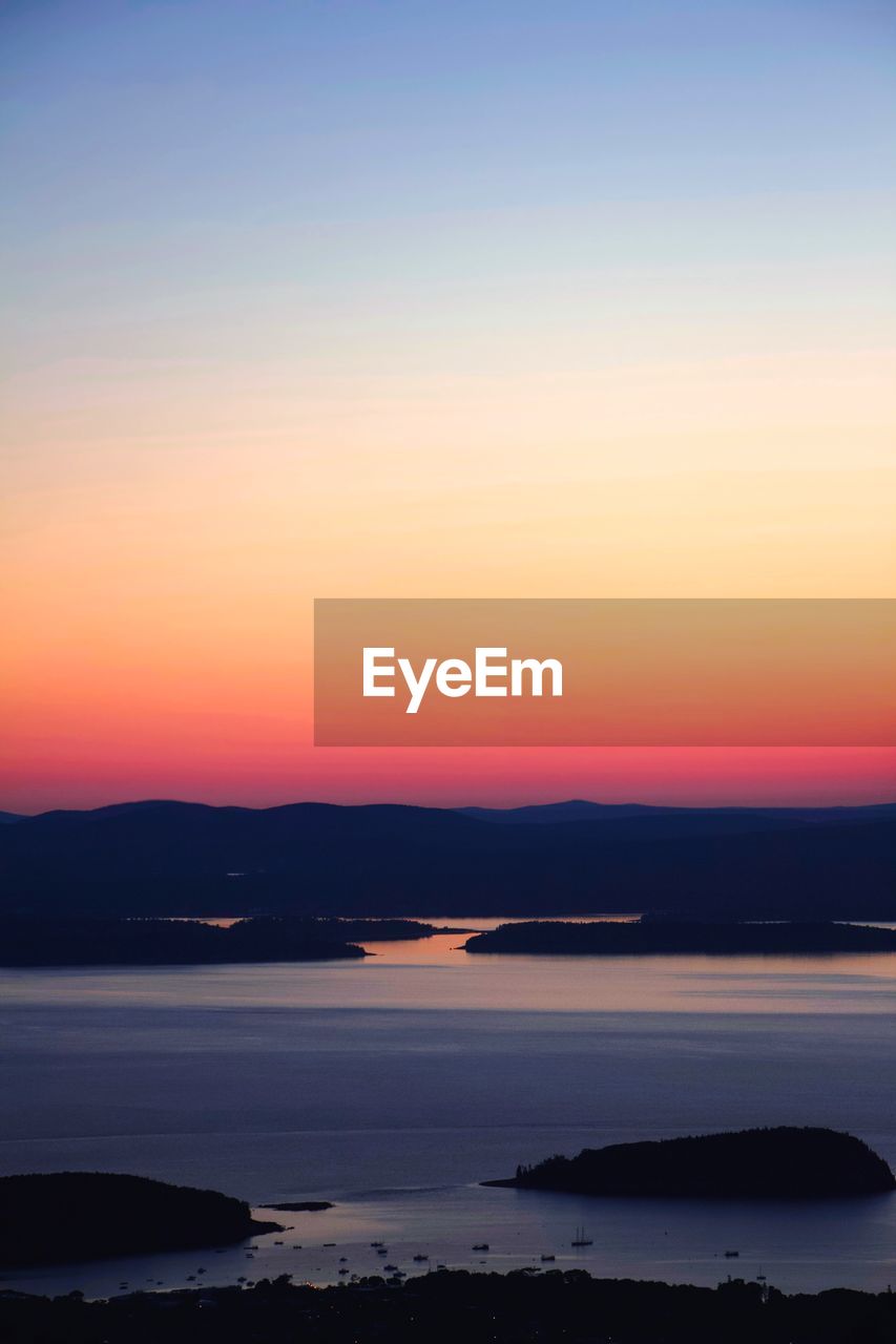 Scenic view of sea against romantic sky at sunset