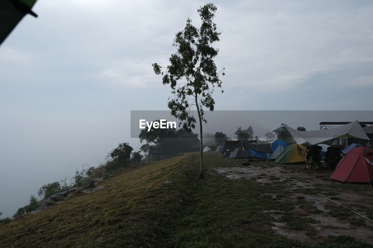 sky, cloud, plant, nature, tent, environment, mountain, camping, tree, land, landscape, no people, beauty in nature, scenics - nature, grass, day, outdoors, tranquility, architecture, non-urban scene, travel, wind