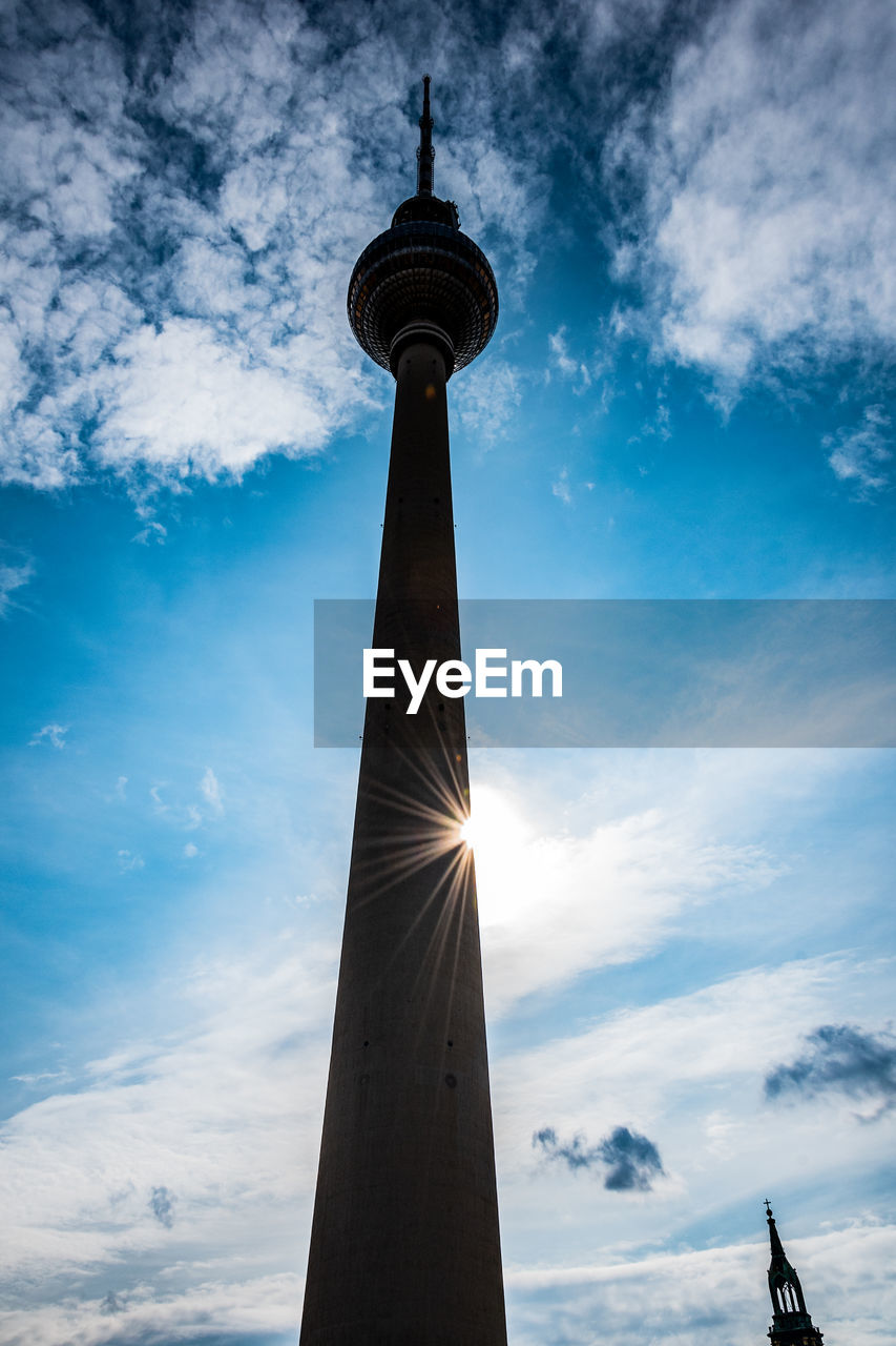 Low angle view of fernsehturm in city against sky