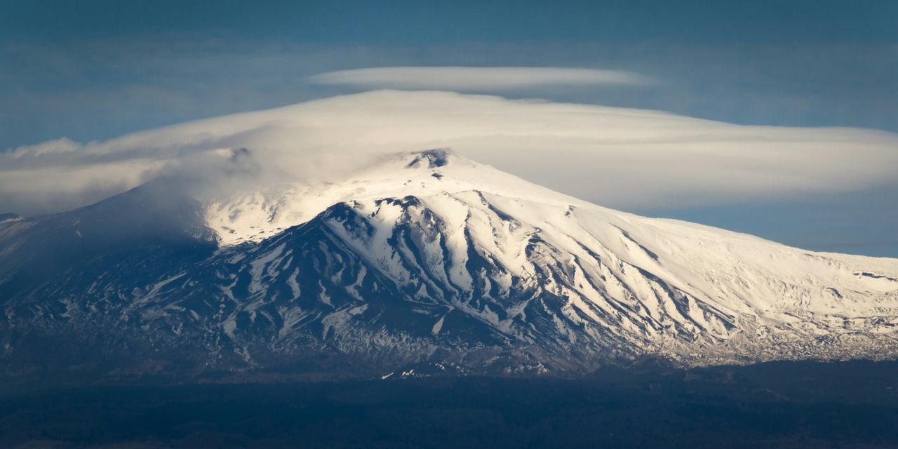 Altocumulus clouds over snowcovered mountain