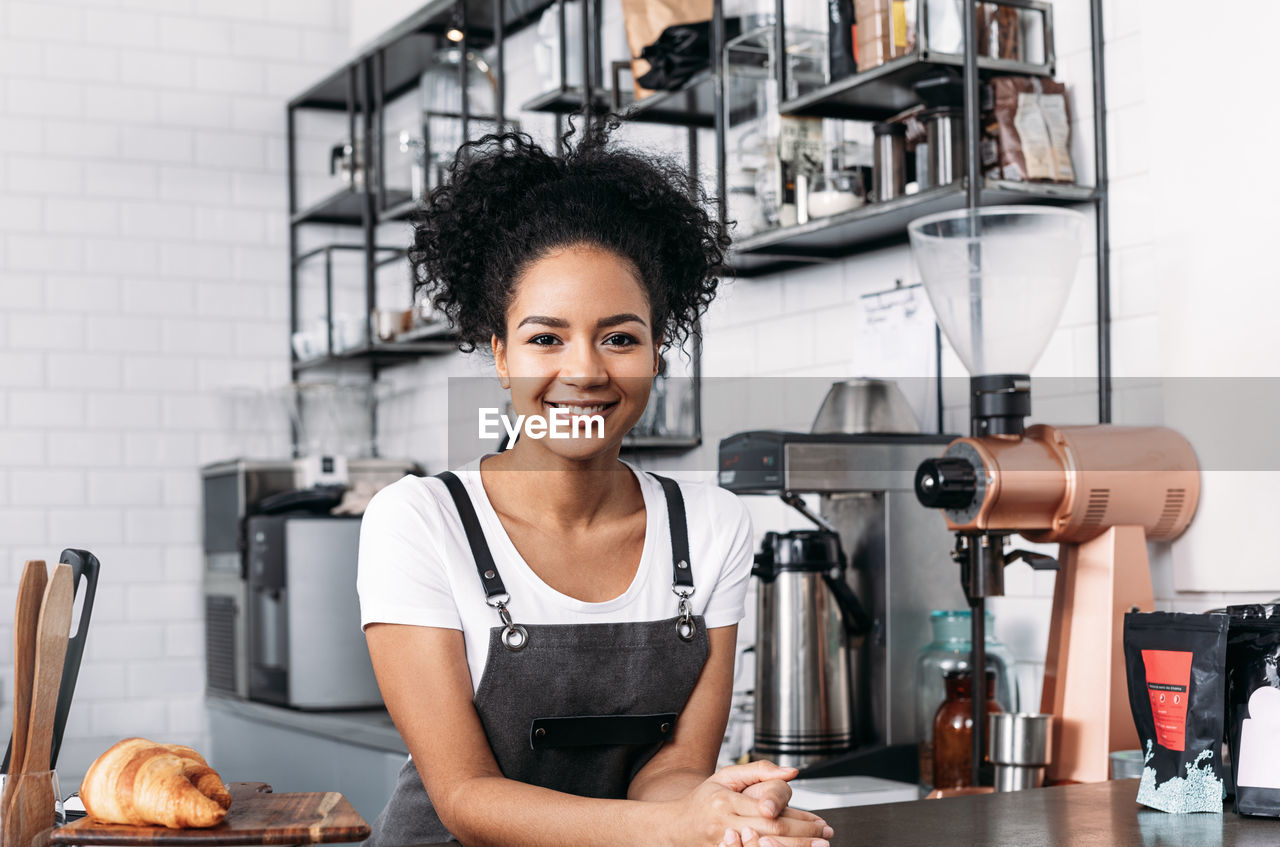 portrait of young woman standing in workshop