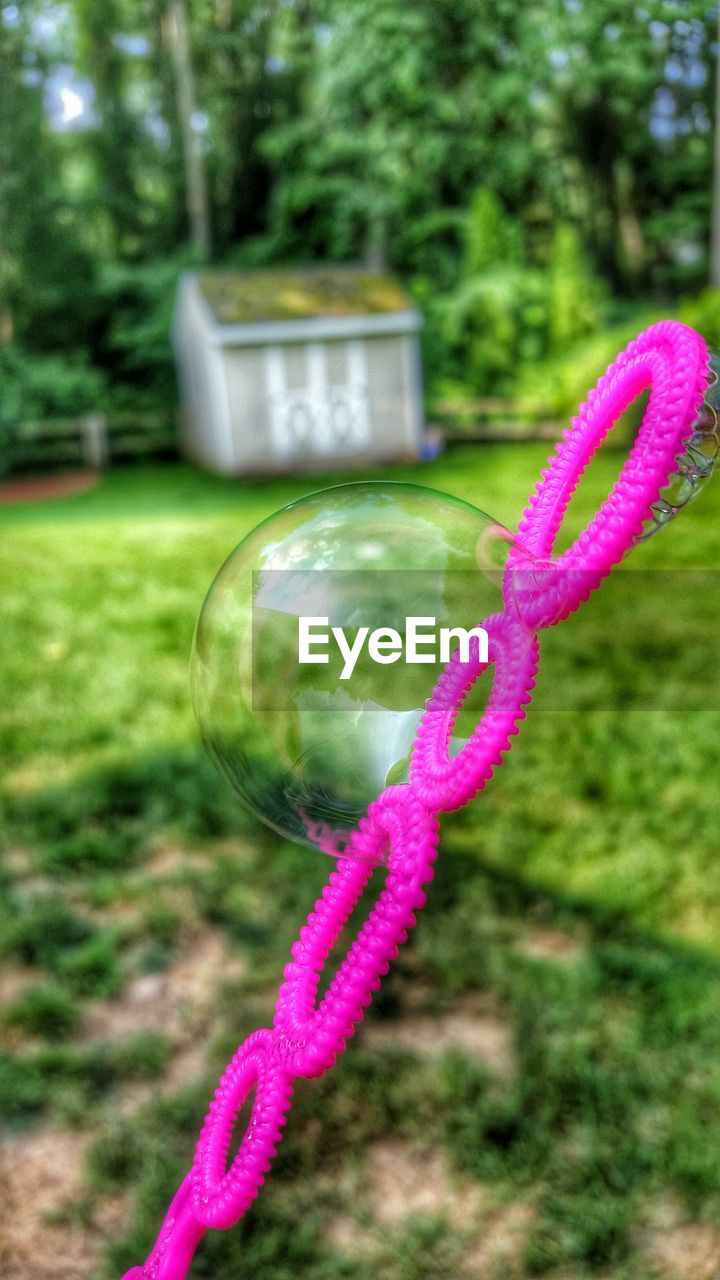 Close-up of pink bubble wand at yard