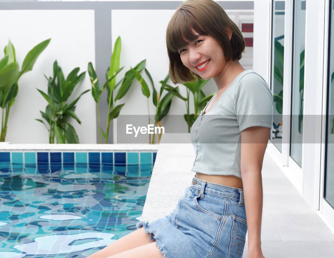 Portrait of a smiling young woman swimming pool