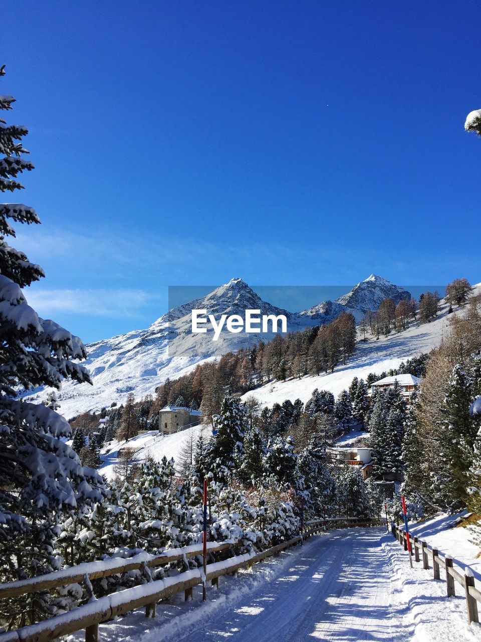 Scenic view of swiss alps against clear blue sky during winter