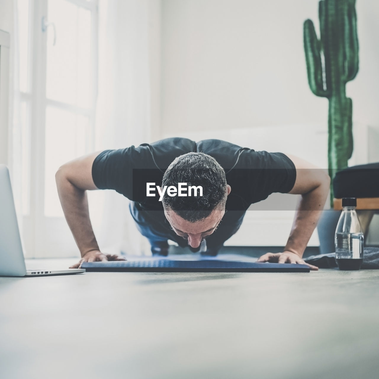 Side view of woman exercising in gym