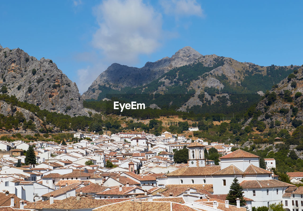 High angle view of townscape and mountains against sky