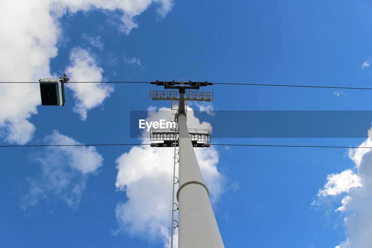 Low angle view of cable car pole against sky