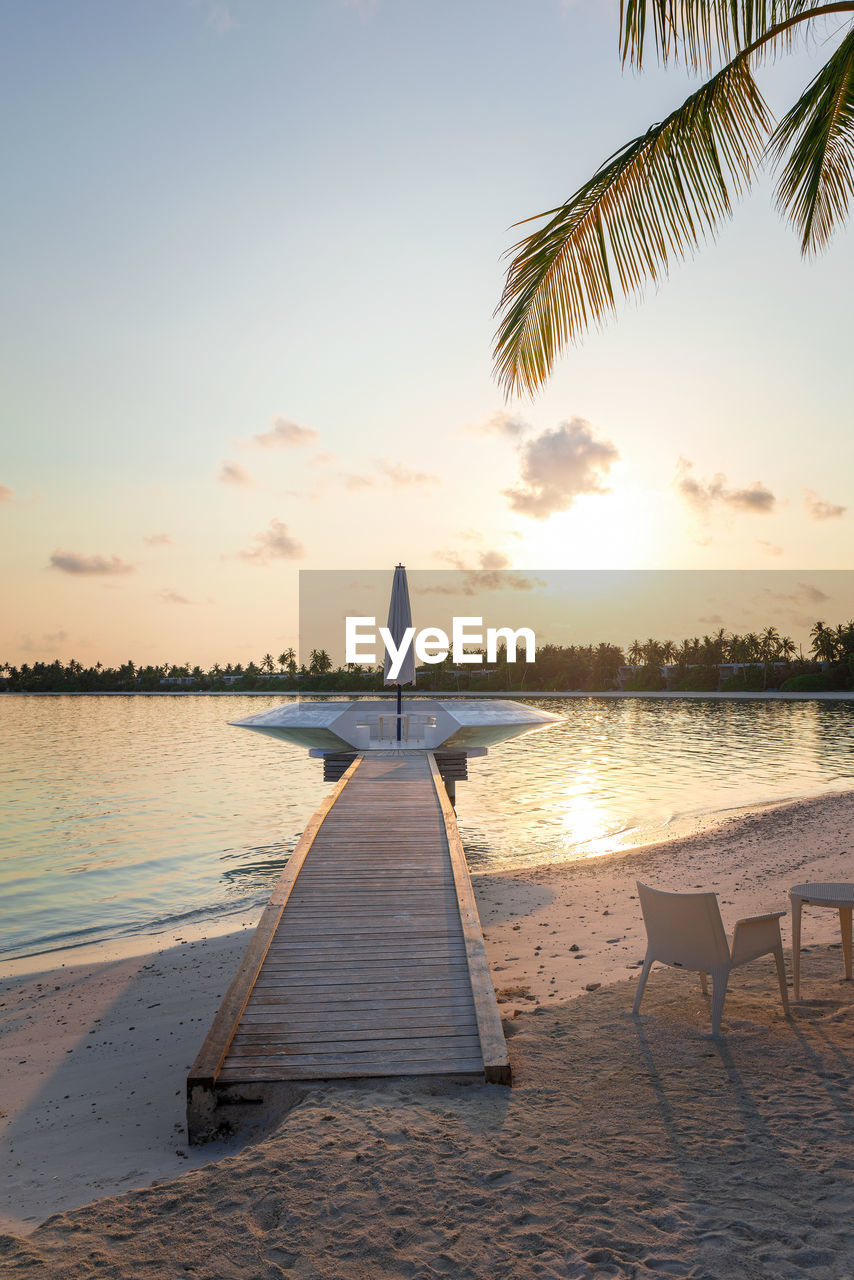 Wooden pier, jetty at tropical island resort in early morning, maldives. 