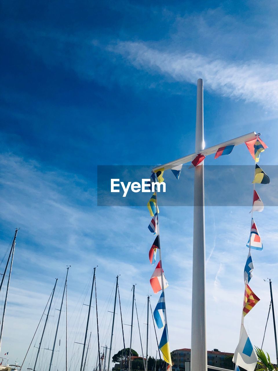 Low angle view of flags against blue sky