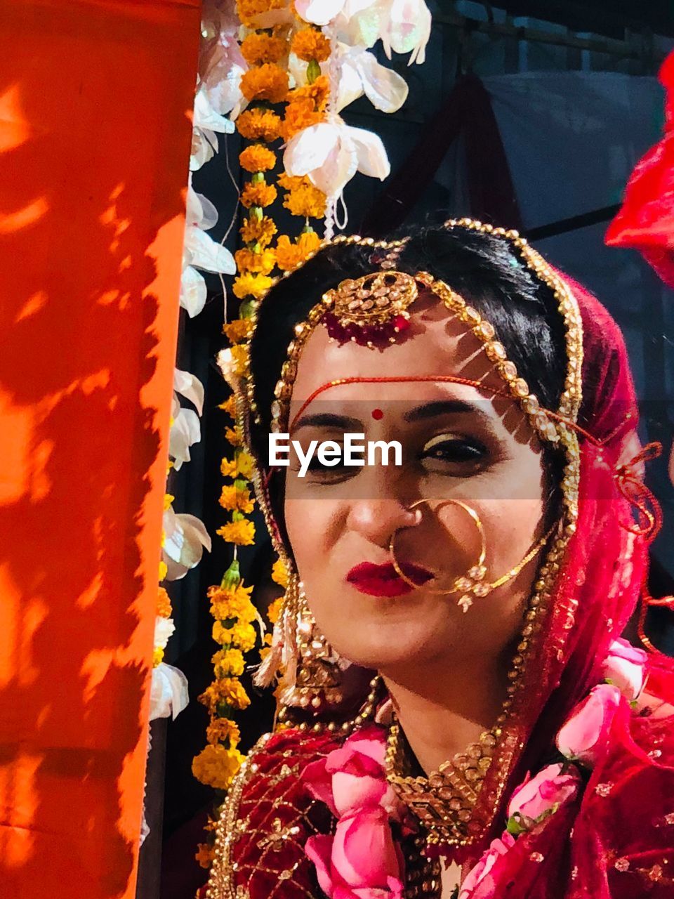 Close-up portrait of smiling young bride during wedding ceremony