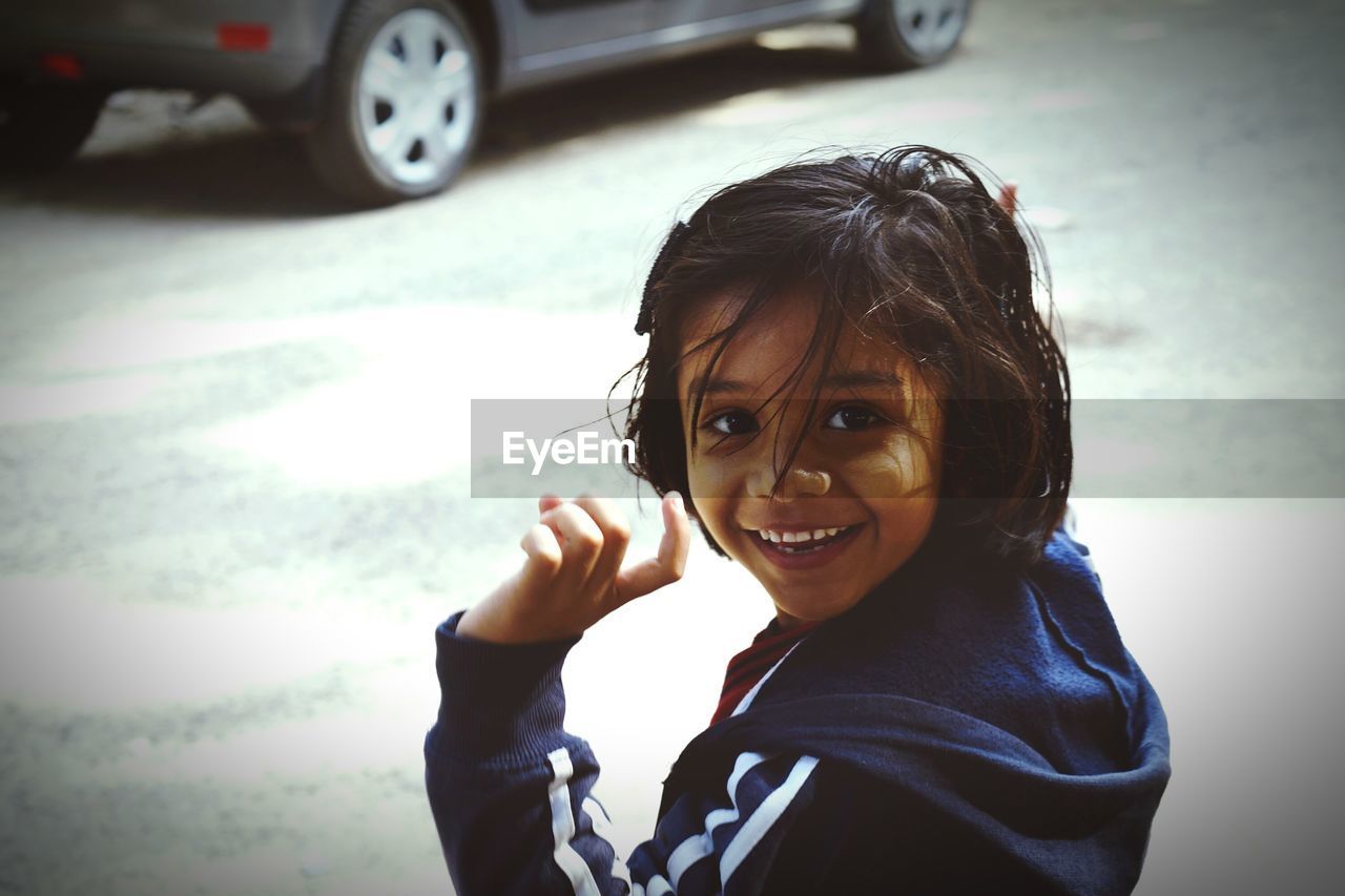 Portrait of smiling girl on street