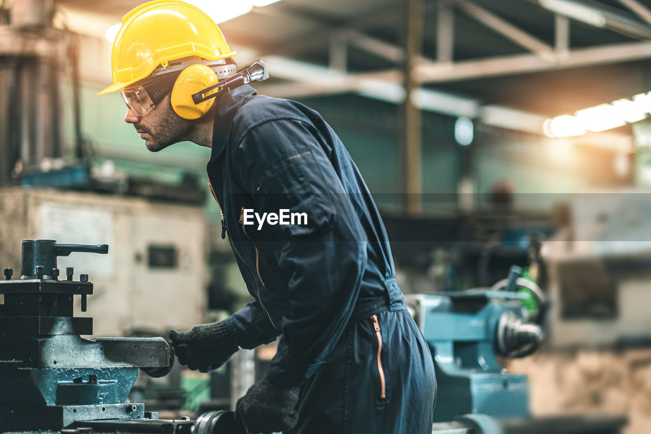 MAN WORKING IN MACHINE