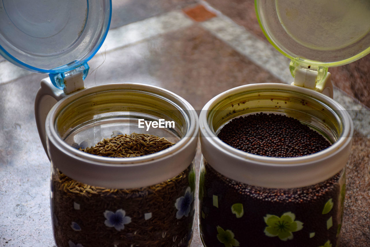 HIGH ANGLE VIEW OF POTTED PLANTS IN GLASS JAR ON TABLE