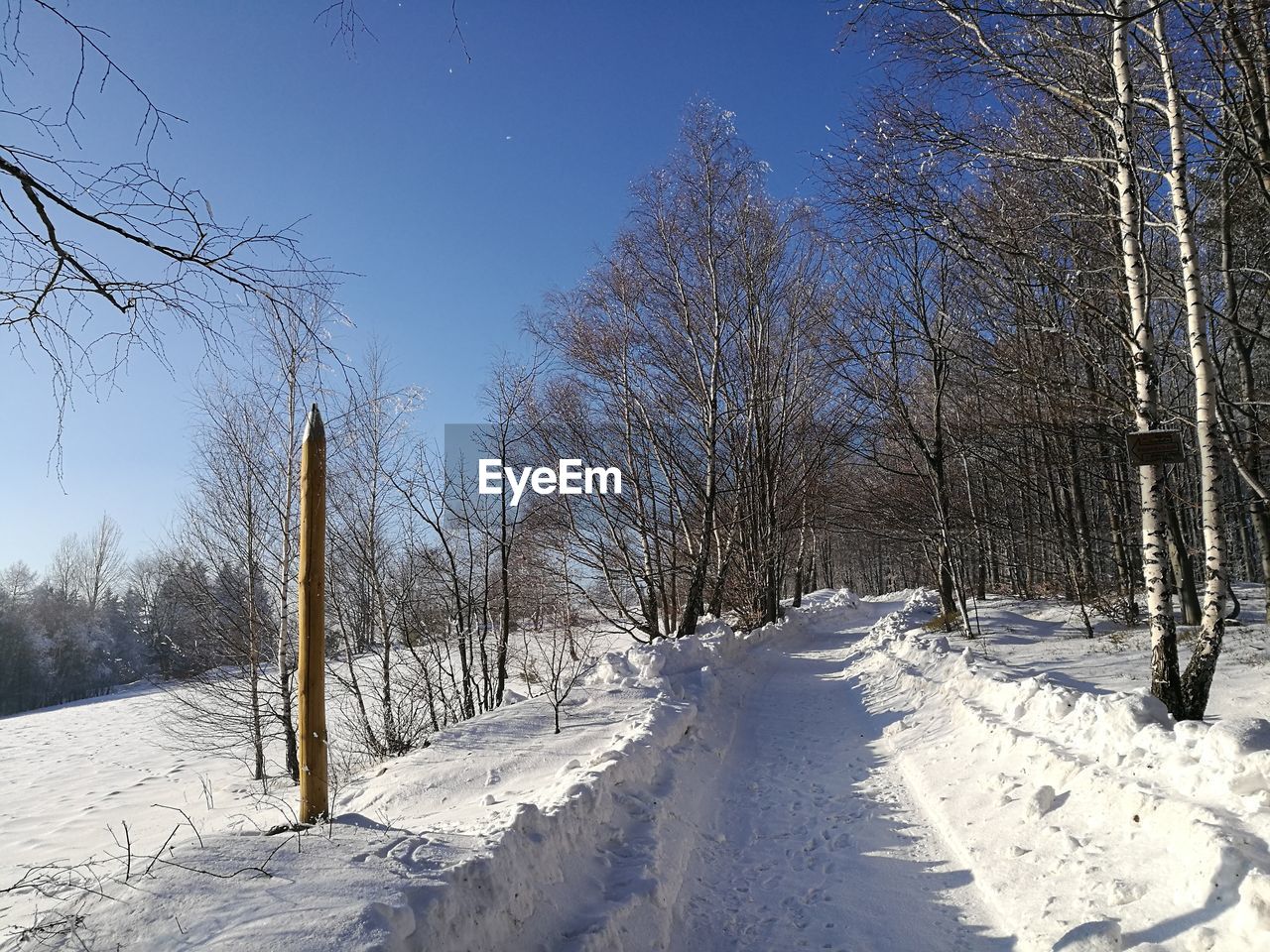 Snow covered landscape against clear sky