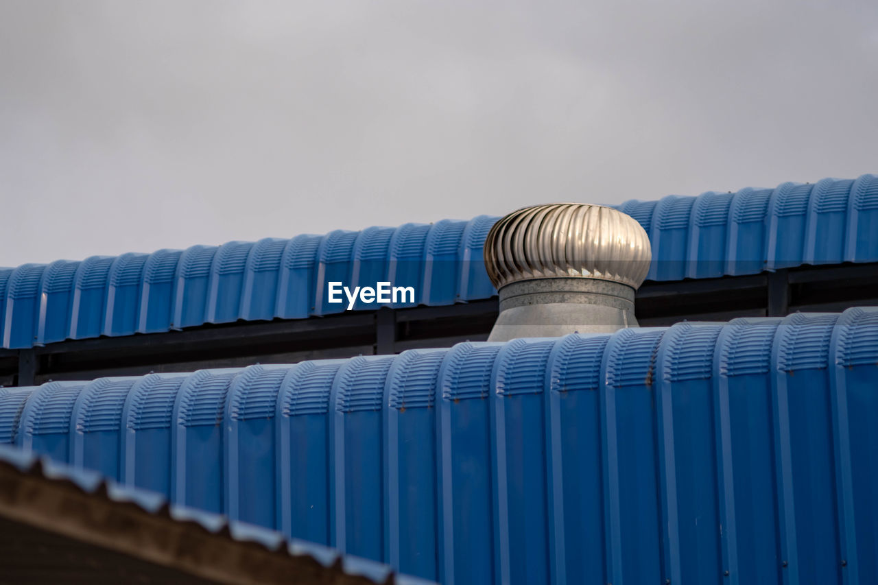 Low angle view of roof against blue sky