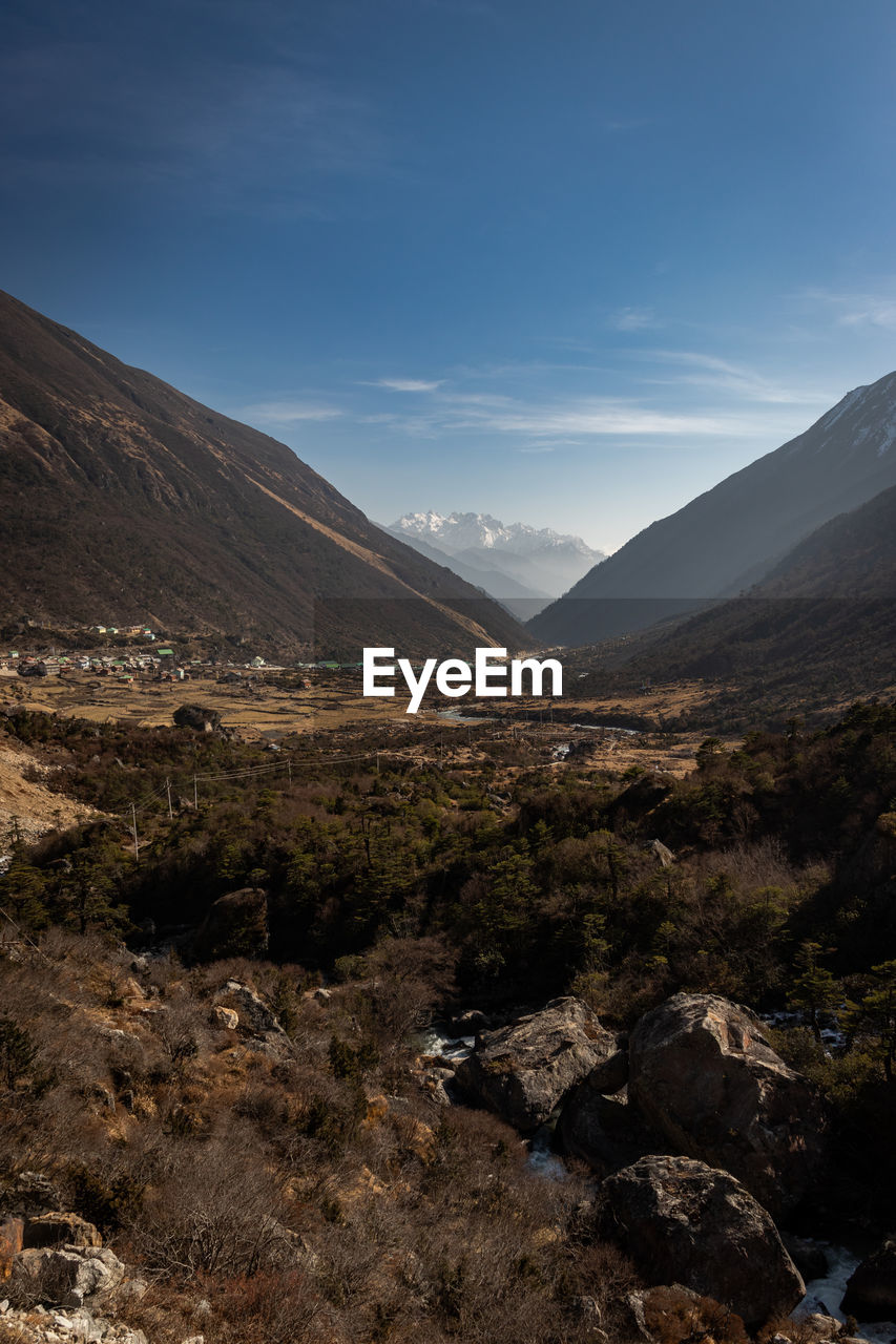 Scenic view of mountains valley against bright blue  sky at morning 