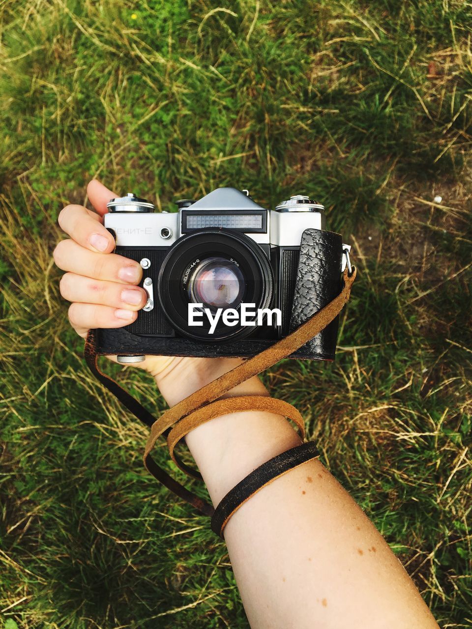 Close-up of human hand holding camera