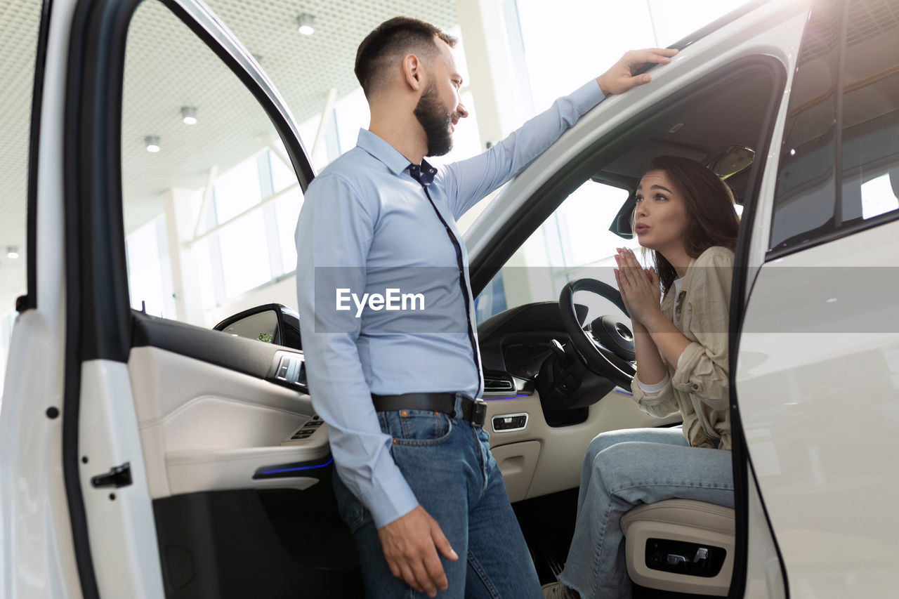 side view of woman sitting in car