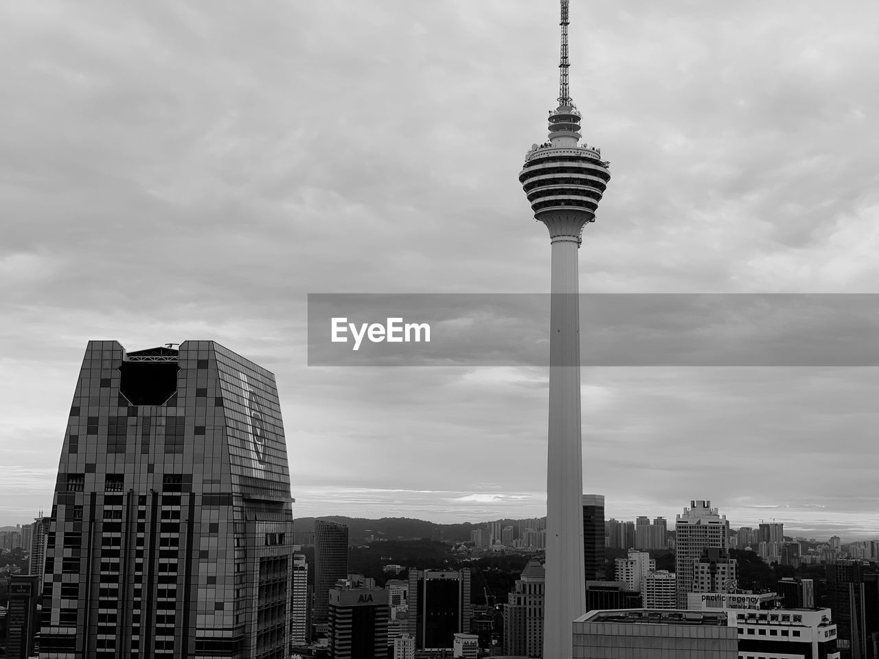 View of buildings in city against cloudy sky