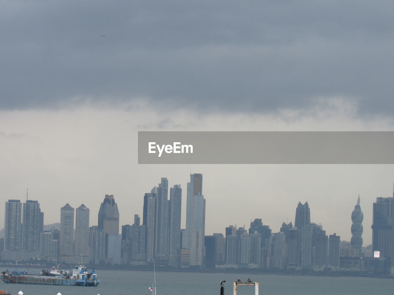 MODERN BUILDINGS BY SEA AGAINST SKY