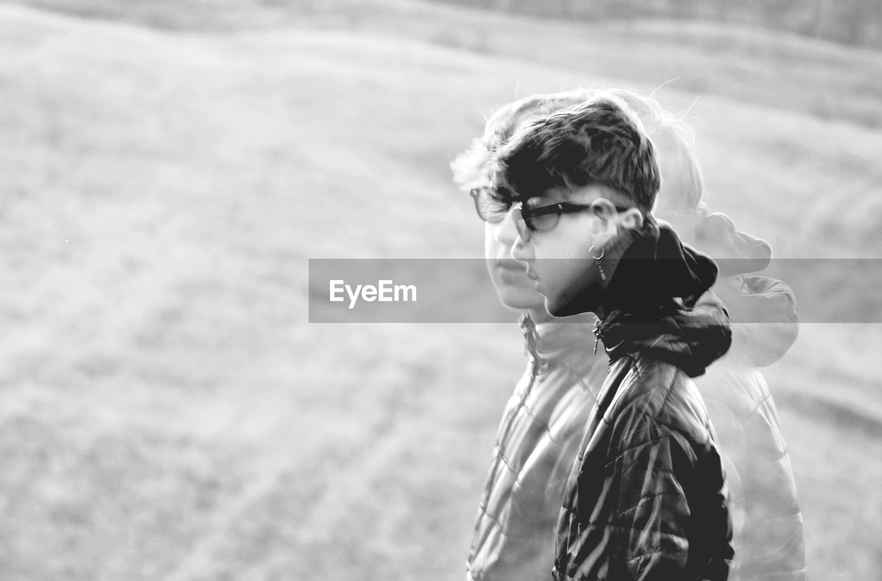 Young man looking away on field