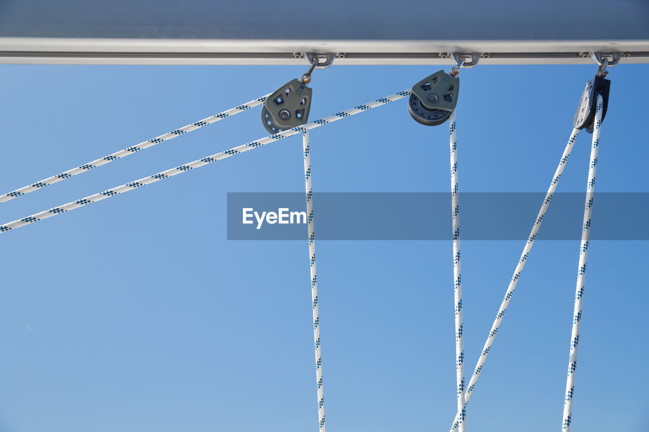 LOW ANGLE VIEW OF CHAIN HANGING AGAINST SKY