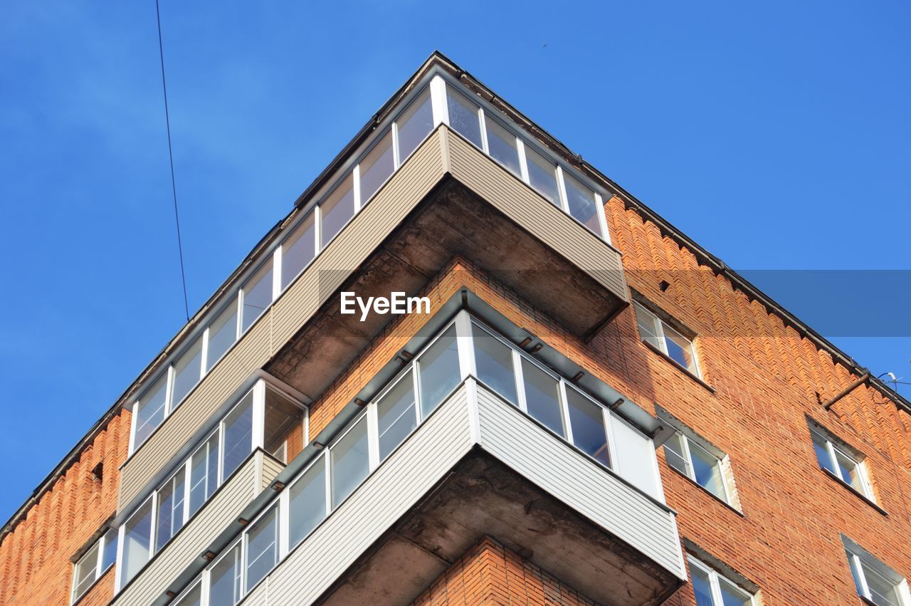 Low angle view of building against clear blue sky