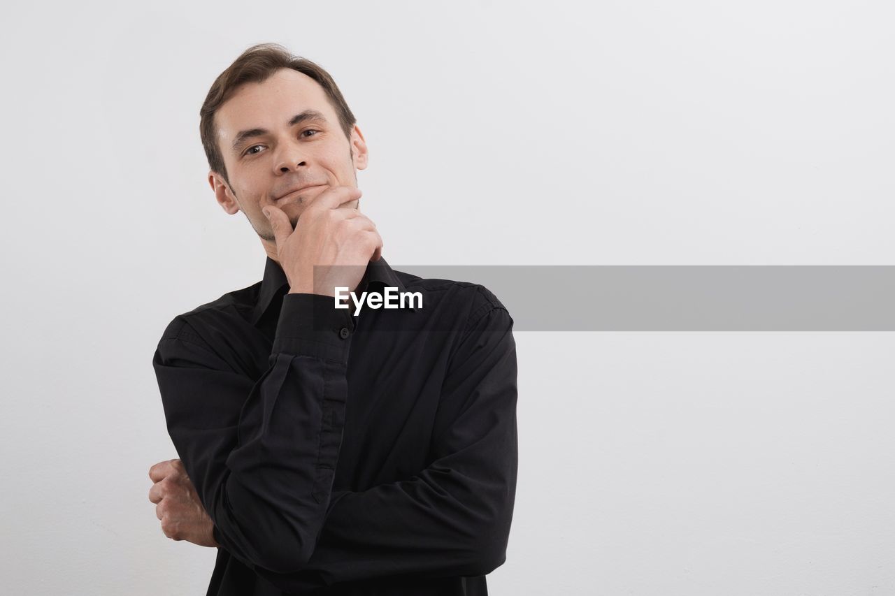 one person, adult, studio shot, portrait, indoors, business, copy space, waist up, men, white background, businessman, front view, gray background, gray, looking, clothing, person, looking at camera, emotion, standing, contemplation, business finance and industry, hand, formal wear, young adult, conversation, serious