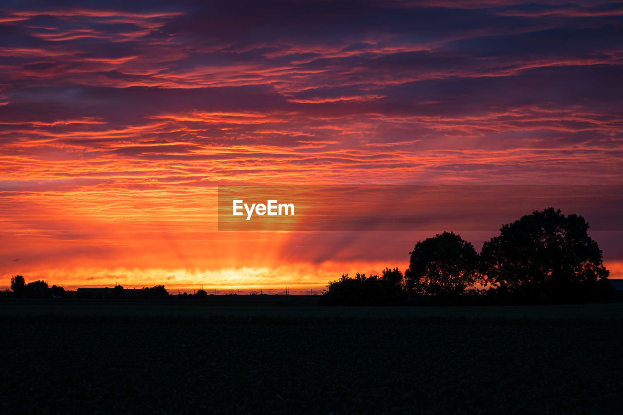 Stunning yellow, orange and purple colors, sunbeams and texture in the clouds during sunset