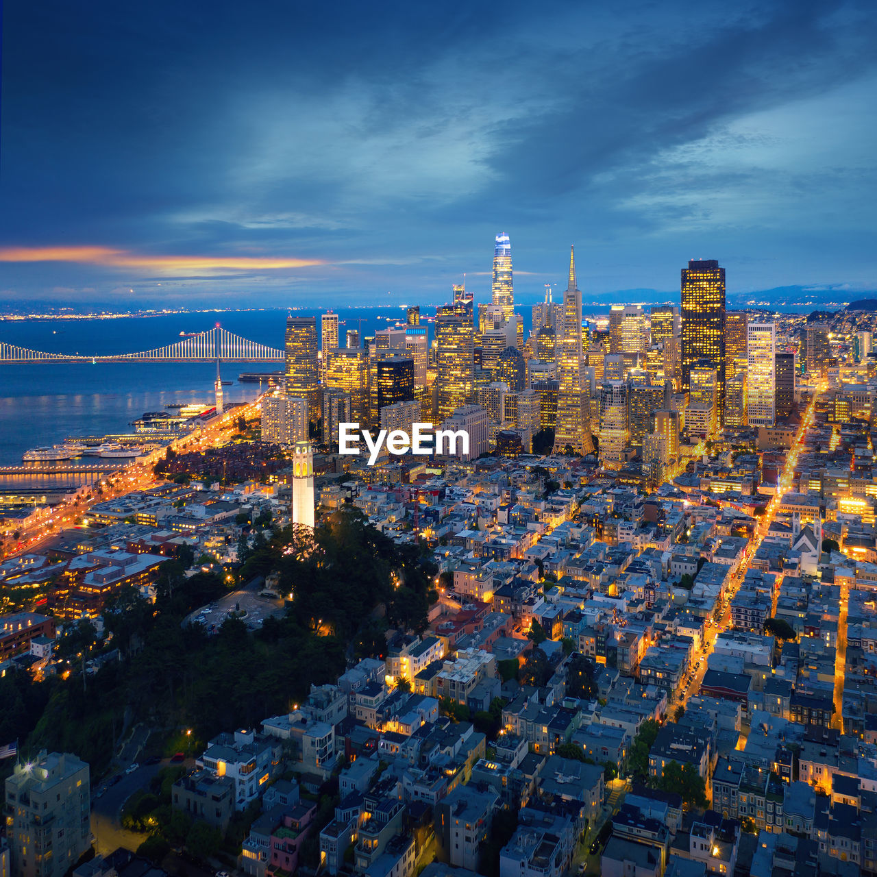 HIGH ANGLE VIEW OF ILLUMINATED CITY BUILDINGS AGAINST SKY