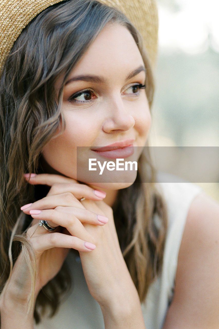 portrait of young woman looking away outdoors