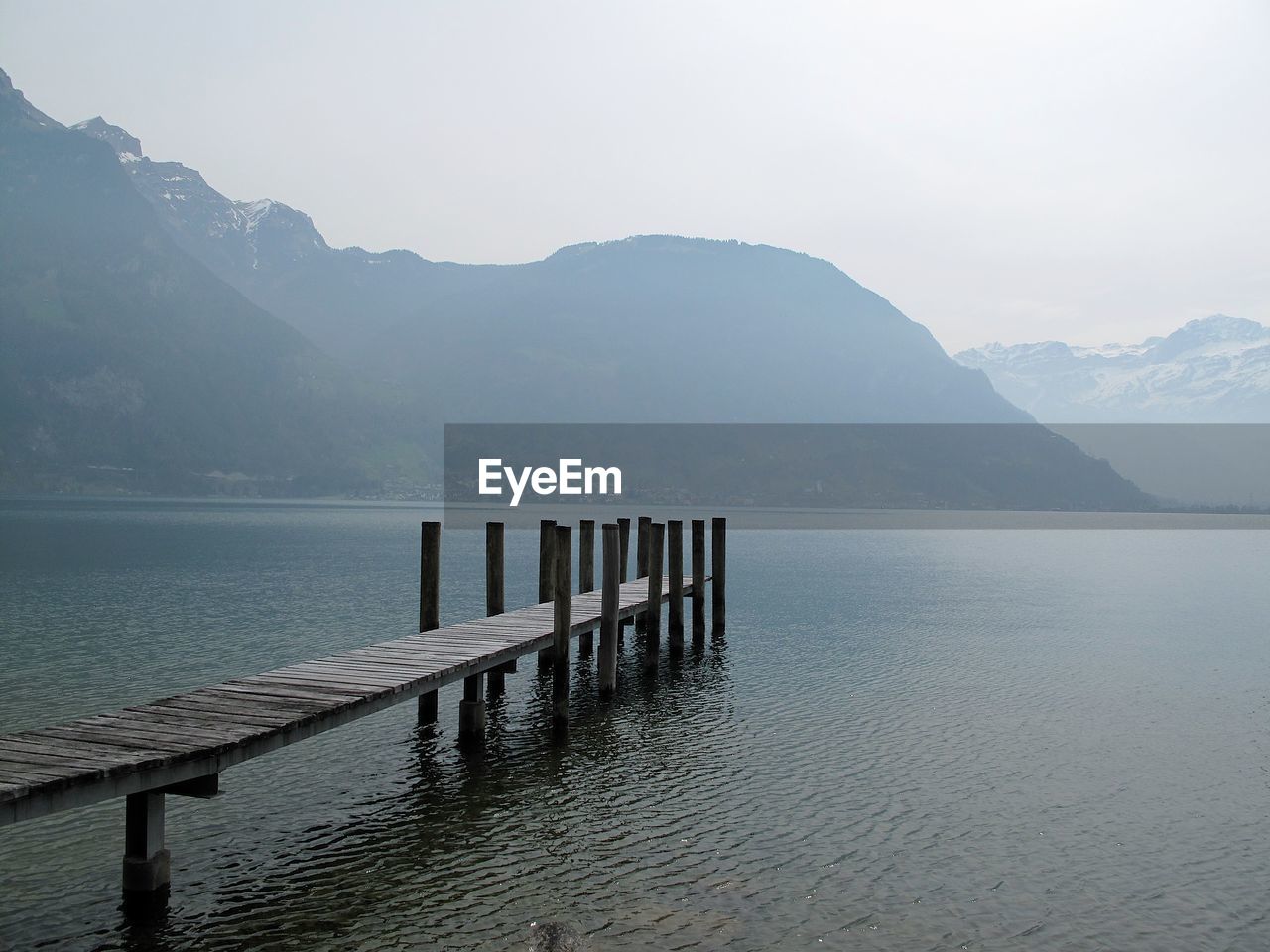 Pier over lake against mountains