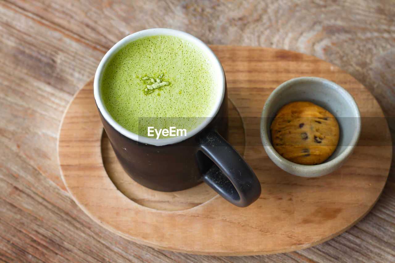 Close up hot greentea matcha latte wood background