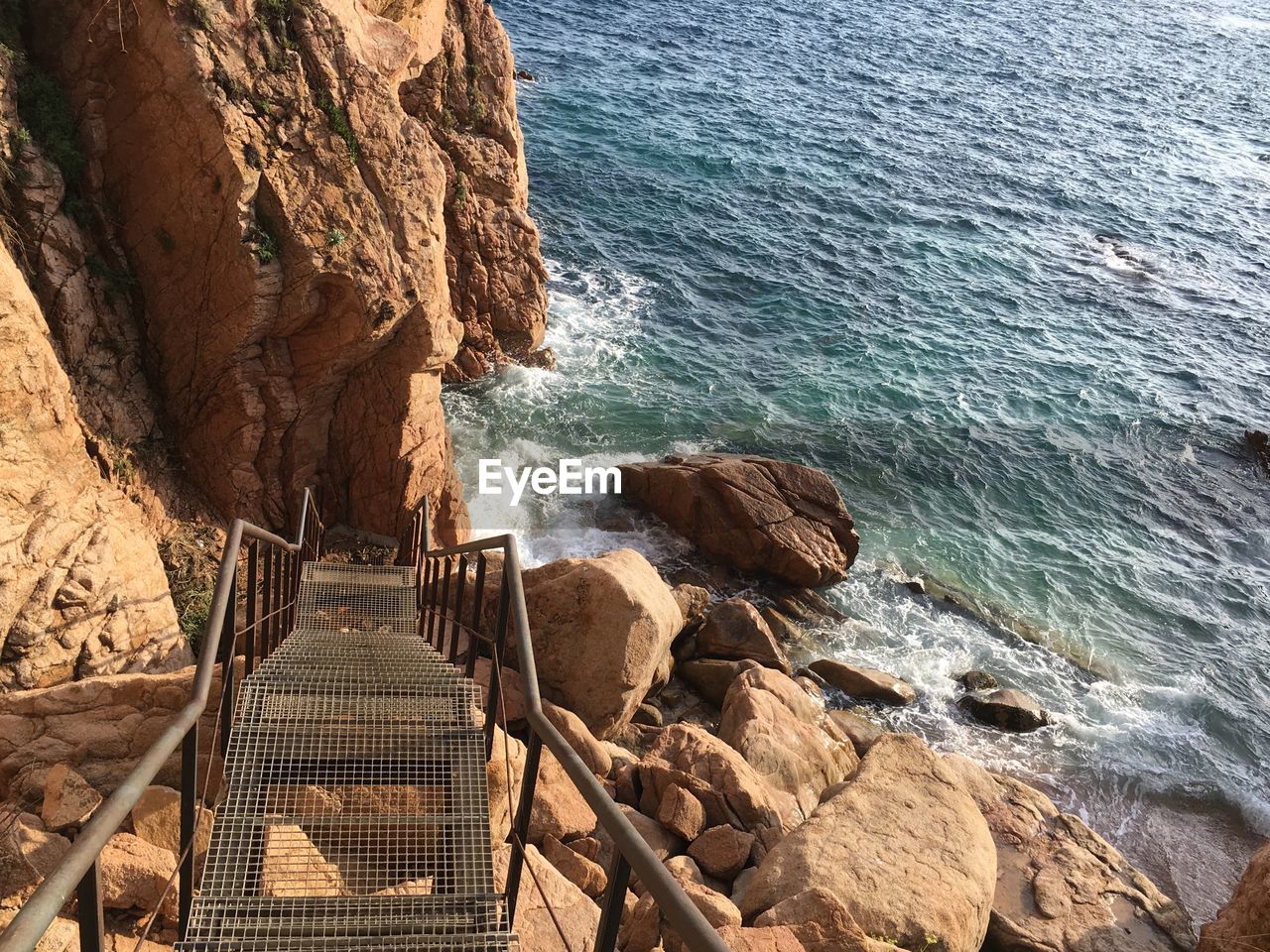 View of old stairs to beautiful rock beach